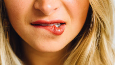 Woman biting lip with red lipstick